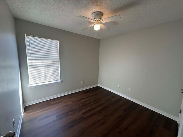 empty room with a textured ceiling, dark wood-type flooring, and ceiling fan