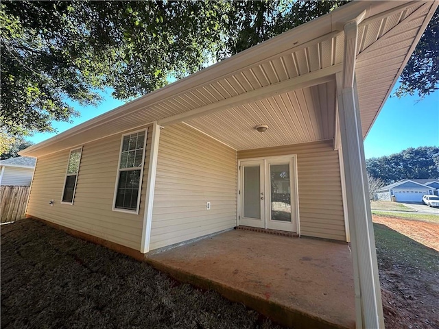 view of exterior entry with a patio area