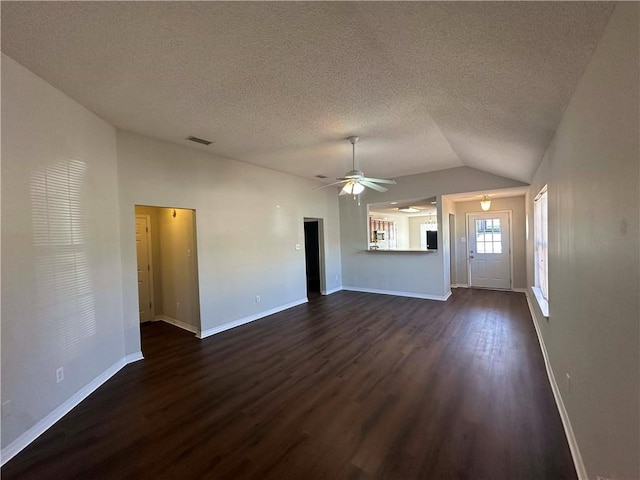 unfurnished living room with ceiling fan, dark hardwood / wood-style flooring, vaulted ceiling, and a textured ceiling