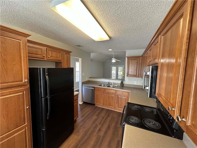 kitchen with sink, a textured ceiling, dark hardwood / wood-style floors, ceiling fan, and stainless steel appliances