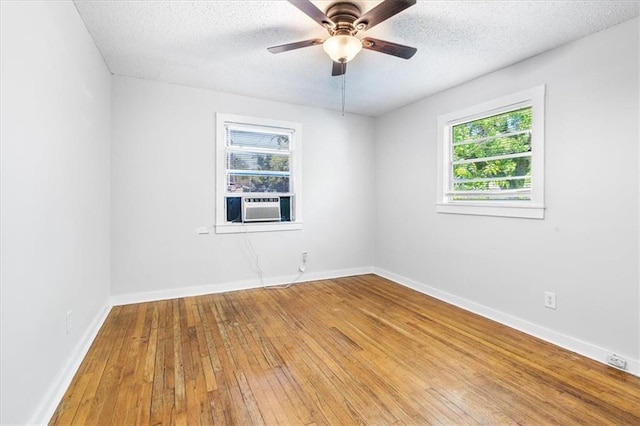 1101 Elmira St, Mobile, AL 36604 - unfurnished room with hardwood / wood-style flooring, cooling unit, a ceiling fan, a textured ceiling, and baseboards