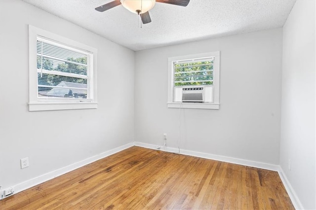 1101 Elmira St, Mobile, AL 36604 - unfurnished room with a ceiling fan, cooling unit, wood finished floors, a textured ceiling, and baseboards
