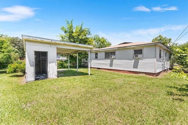 1101 Elmira St, Mobile, AL 36604 - rear view of property featuring a yard, an outbuilding, a storage unit, and a carport