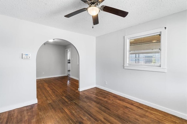 1101 Elmira St, Mobile, AL 36604 - unfurnished room featuring arched walkways, a ceiling fan, wood finished floors, baseboards, and a textured ceiling