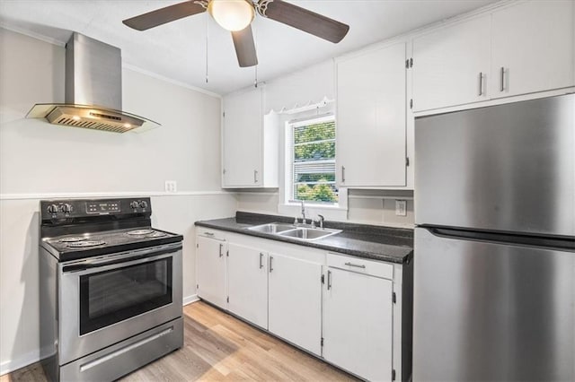 1101 Elmira St, Mobile, AL 36604 - kitchen with appliances with stainless steel finishes, wall chimney exhaust hood, a sink, dark countertops, and light wood-style floors