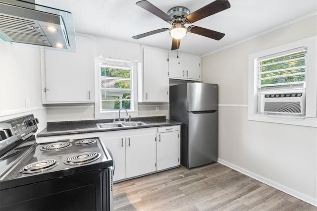 1101 Elmira St, Mobile, AL 36604 - kitchen with black electric range oven, freestanding refrigerator, a sink, under cabinet range hood, and healthy amount of natural light