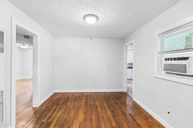 1101 Elmira St, Mobile, AL 36604 - spare room featuring wood-type flooring, a textured ceiling, cooling unit, and baseboards
