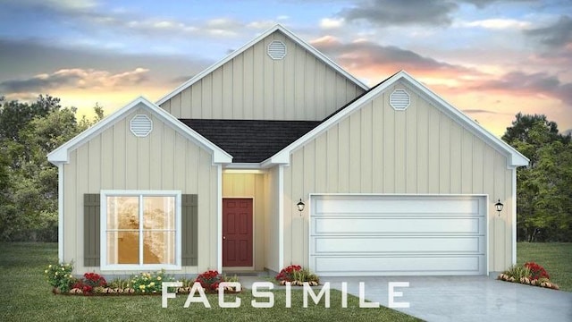 view of front of home featuring a lawn and a garage