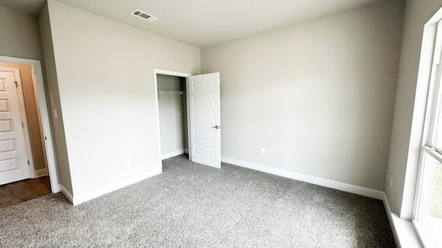 unfurnished bedroom with carpet floors and a closet