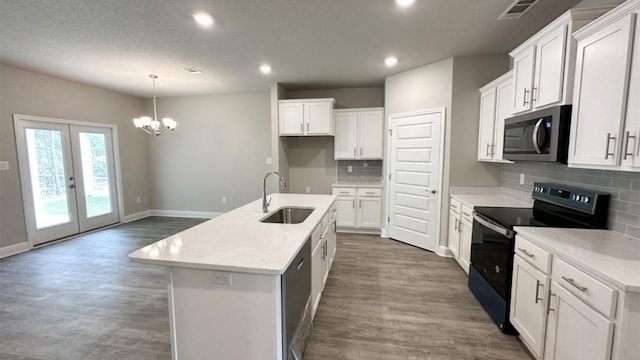 kitchen with white cabinets, a center island with sink, black range with electric stovetop, and sink