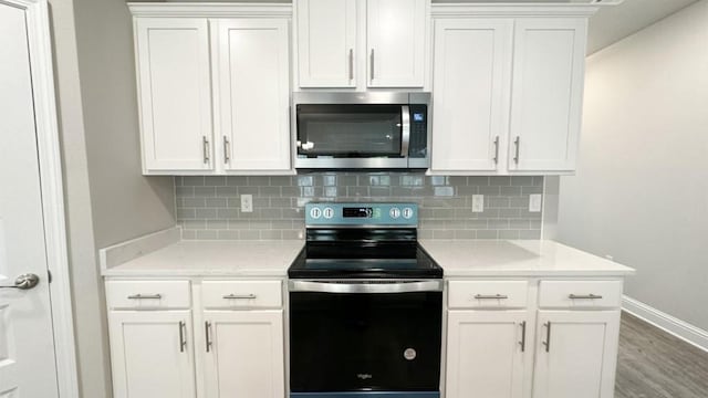 kitchen featuring backsplash, white cabinetry, and stainless steel appliances