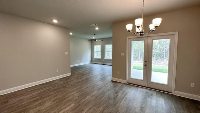 entryway featuring french doors, ceiling fan with notable chandelier, and dark wood-type flooring