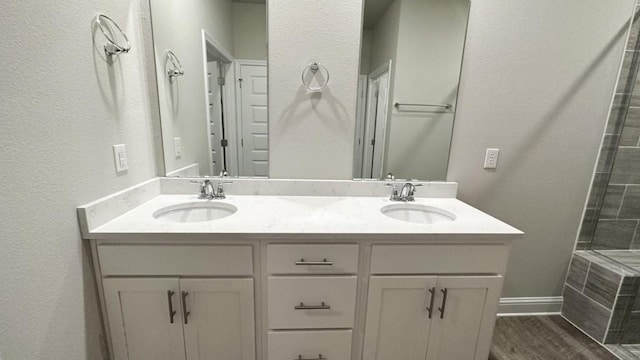 bathroom with a shower, vanity, and hardwood / wood-style flooring