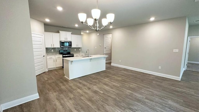 kitchen with a kitchen island with sink, dark wood-type flooring, hanging light fixtures, white cabinetry, and stainless steel appliances