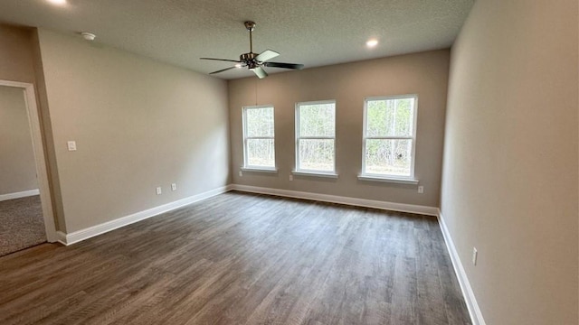 unfurnished room with ceiling fan, dark hardwood / wood-style floors, and a textured ceiling