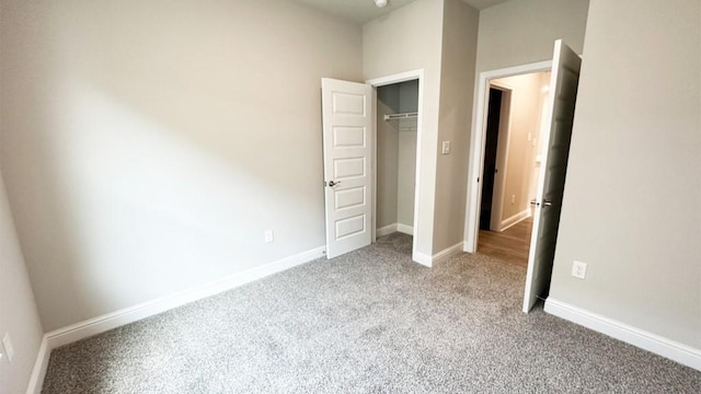 unfurnished bedroom with light carpet and a closet