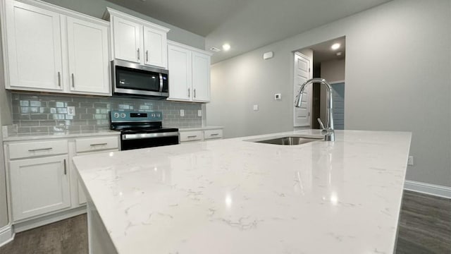 kitchen featuring white cabinets, stainless steel appliances, light stone countertops, and sink