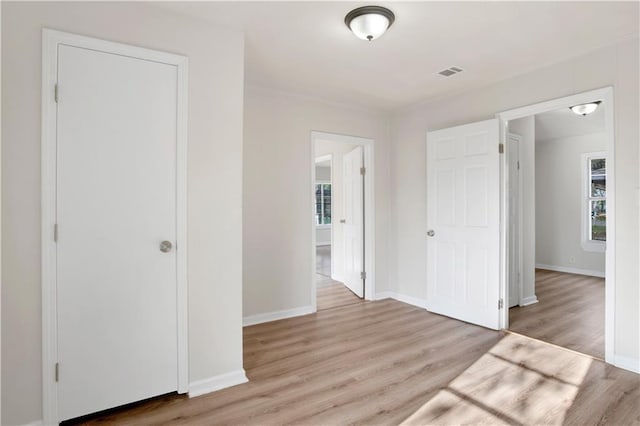 interior space featuring multiple windows and light wood-type flooring