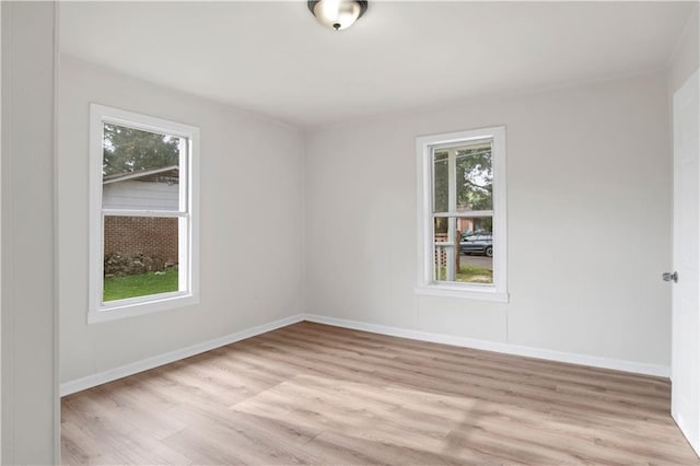 unfurnished room featuring light hardwood / wood-style floors and a healthy amount of sunlight