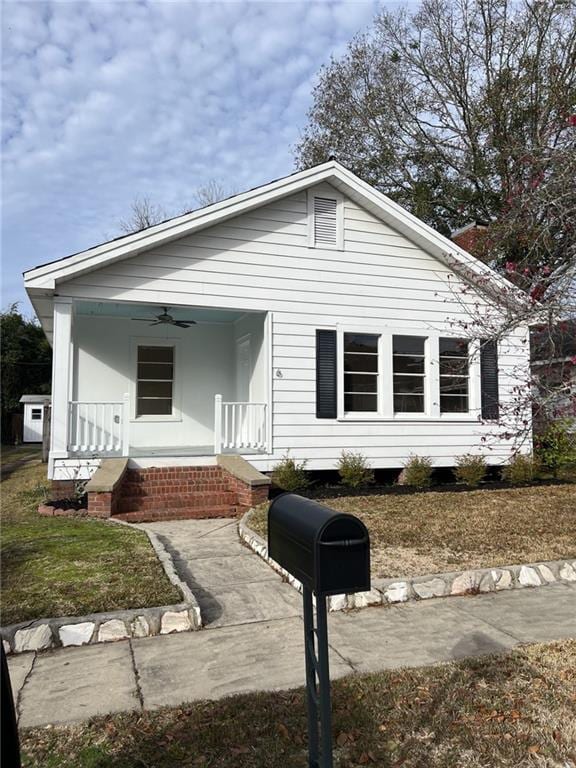 bungalow-style home with ceiling fan and a porch