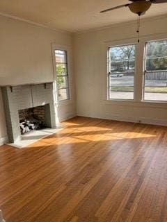 unfurnished living room featuring light hardwood / wood-style flooring, ceiling fan, and a healthy amount of sunlight