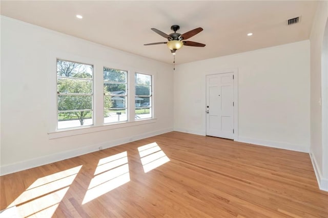 empty room featuring ceiling fan and light wood-type flooring