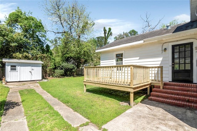 view of yard featuring a storage unit and a deck