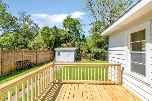 deck featuring a lawn and a storage unit