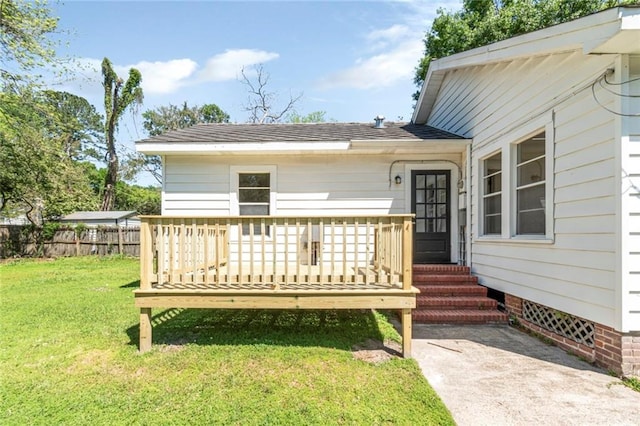 property entrance featuring a yard and a deck