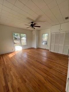 unfurnished bedroom with ceiling fan and hardwood / wood-style flooring