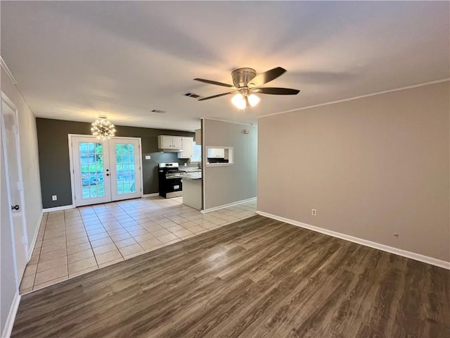 8636 Boe Rd, Irvington, AL 36544 - unfurnished living room with light wood-style flooring, french doors, baseboards, a ceiling fan, and crown molding
