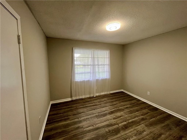 8636 Boe Rd, Irvington, AL 36544 - unfurnished room with a textured ceiling, dark wood finished floors, and baseboards