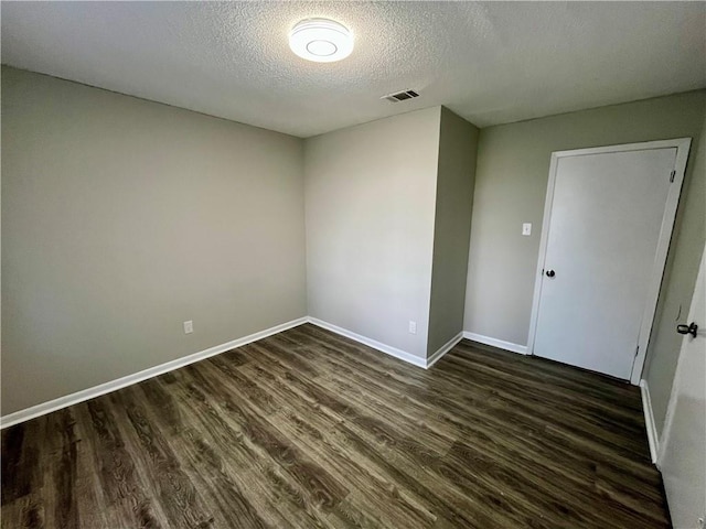 8636 Boe Rd, Irvington, AL 36544 - spare room with a textured ceiling, dark wood-style floors, and baseboards