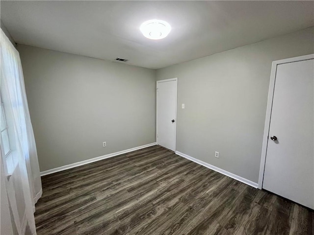 8636 Boe Rd, Irvington, AL 36544 - unfurnished bedroom with dark wood finished floors and baseboards