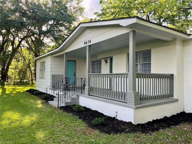 8636 Boe Rd, Irvington, AL 36544 - view of front of property with a front lawn, a porch, and brick siding