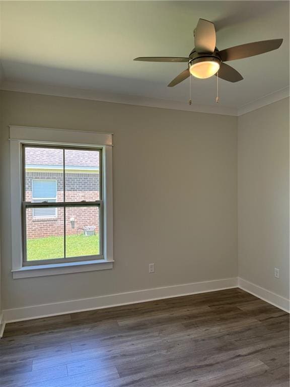 unfurnished room with crown molding, ceiling fan, and dark hardwood / wood-style flooring