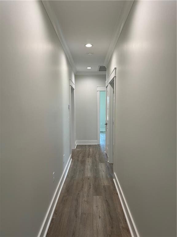 corridor featuring crown molding and dark hardwood / wood-style flooring