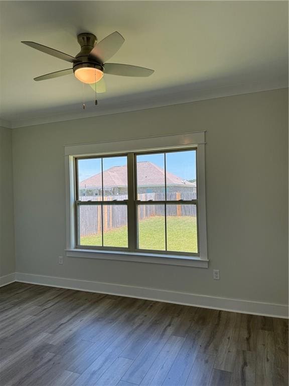 spare room with dark hardwood / wood-style flooring and ceiling fan