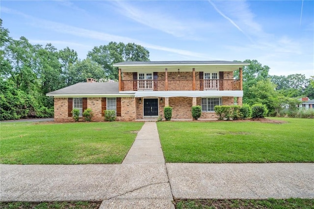 view of front of home featuring a balcony and a front lawn