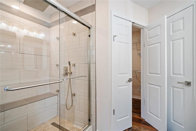 bathroom featuring a shower with shower door