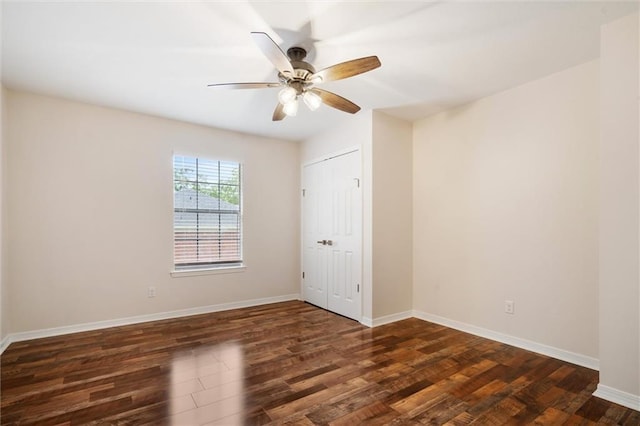 empty room featuring dark hardwood / wood-style floors and ceiling fan