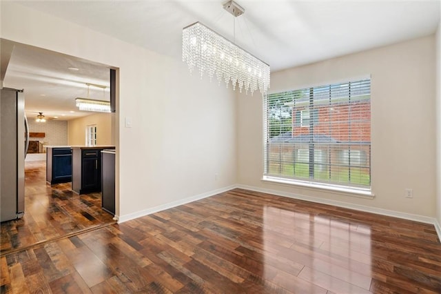 unfurnished dining area featuring dark hardwood / wood-style flooring and a chandelier