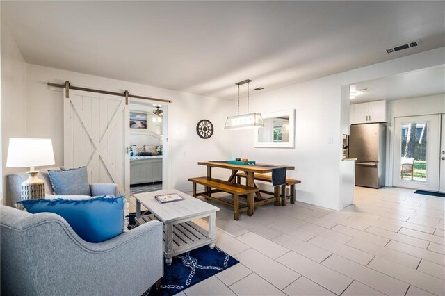 tiled living room with a barn door