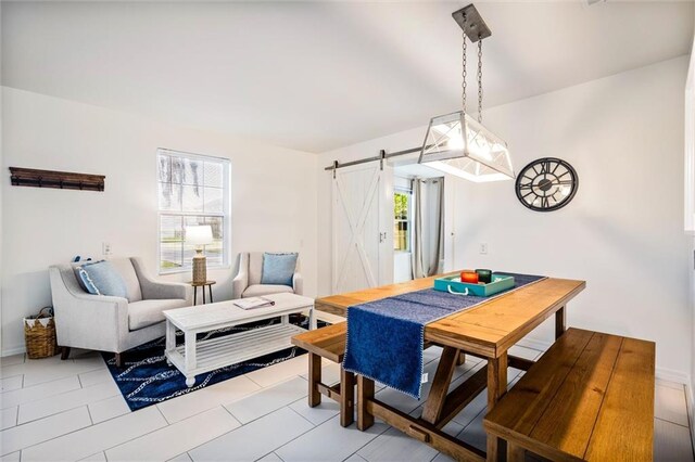 interior space with tile patterned floors and a barn door