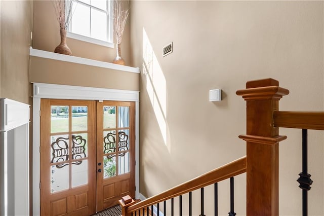 entrance foyer with french doors and a towering ceiling