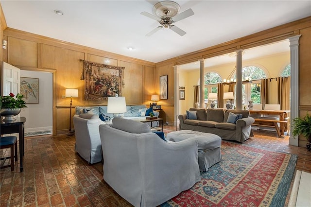 living room with ornate columns and ceiling fan