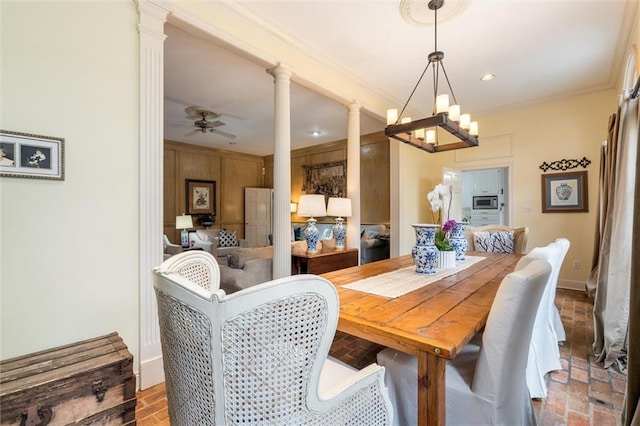 dining area with ornate columns, ceiling fan with notable chandelier, and crown molding