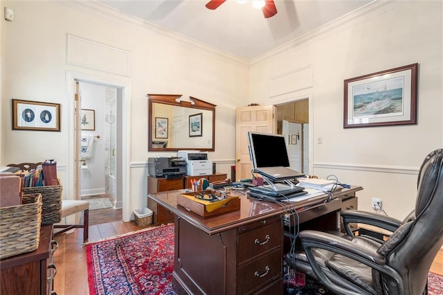 office space featuring wood-type flooring, crown molding, and ceiling fan