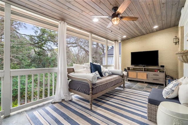 sunroom / solarium with wooden ceiling, ceiling fan, and vaulted ceiling