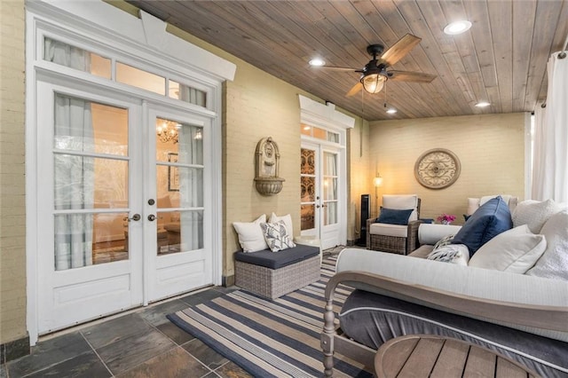 tiled living room with ceiling fan, french doors, and wooden ceiling